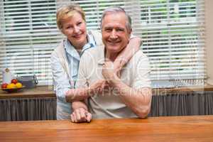 Senior couple smiling at the camera together