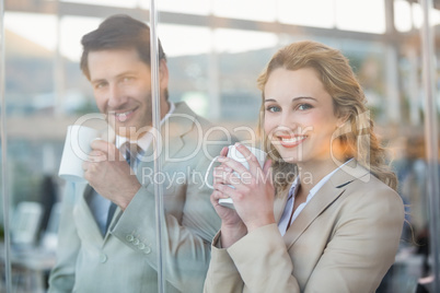 Business people holding cup of coffee through the window