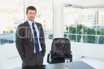 Posing businessman at his desk