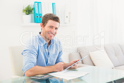 Casual businessman using tablet at desk