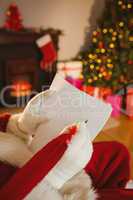Father christmas writing list with a quill