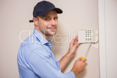 Handyman fixing an alarm system