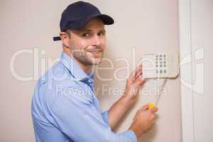 Handyman fixing an alarm system