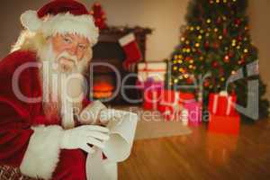 Smiling santa claus holding a scroll