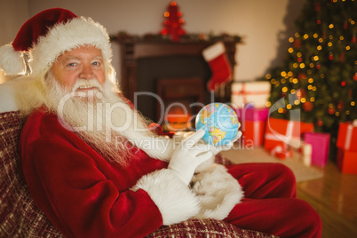 Smiling santa claus holding a globe Smiling santa claus holding a globe