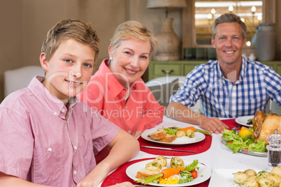 Portrait of grandmother father and son at christmas dinner