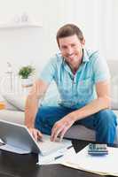Smiling man on a laptop at home