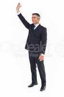 Smiling businessman in suit waving