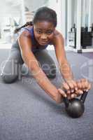 Fit woman working out with kettlebell