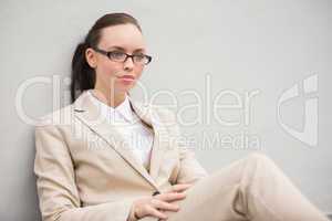 Young businesswoman sitting and thinking