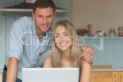 Cute couple using laptop together Cute couple using laptop together