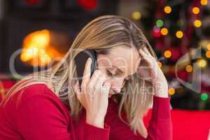 Upset young woman looking down while calling on phone