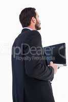 Businessman in suit holding laptop