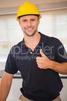 Smiling construction worker giving thumbs up