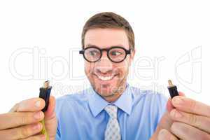 Geeky businessman holding two cables