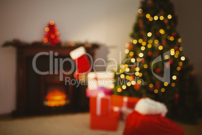 Christmas tree with presents near the fireplace