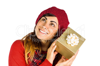 Brunette in hat listening a gift