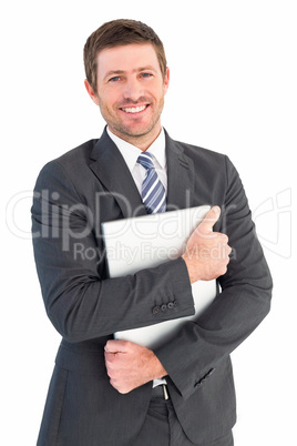 Businessman holding his laptop tightly