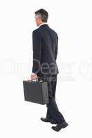 Businessman walking and holding briefcase