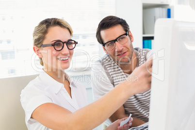 Photo editors looking at computer screen