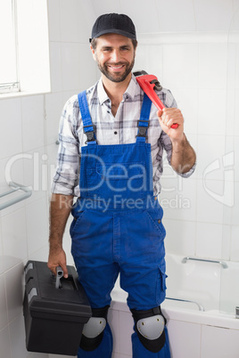 Plumber holding wrench and toolbox