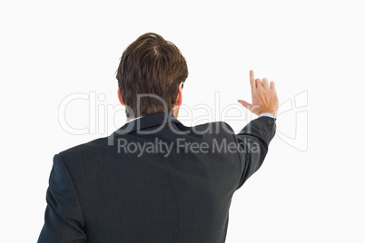 Young businessman touching invisible screen