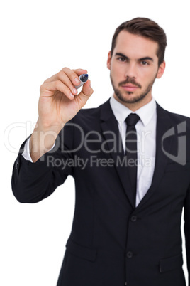 Serious businessman writing with marker