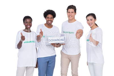 Young smiling volunteers collecting donations