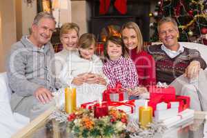 Multi generation family smiling at camera during christmas