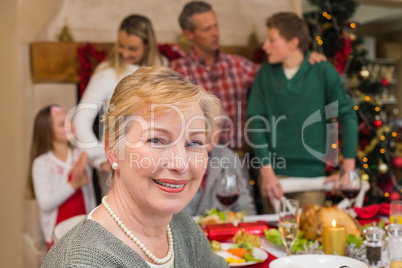 Smiling mature woman posing in front of her family