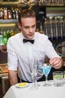 Bartender preparing a drink at bar counter