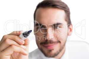 Portrait of happy businessman writing with marker