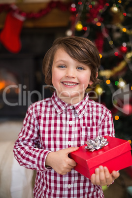 Festive little boy holding a gift Festive little boy holding a gift