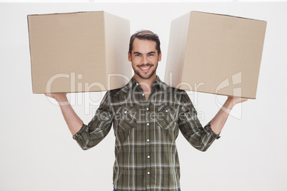 Happy man holding moving boxes