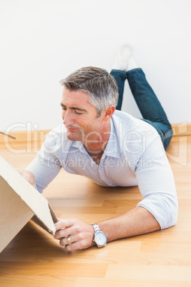 Septic man lying on floor and looking inside the box