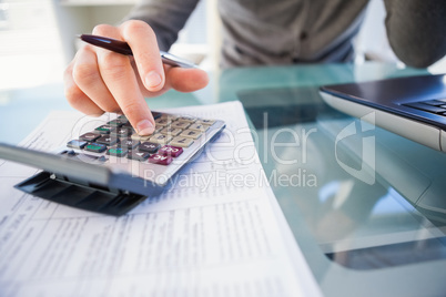 Casual businessman calculating his expenses