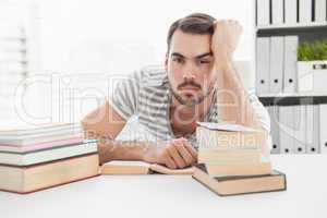 Bored casual businessman studying at his desk