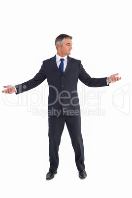 Businessman in suit spreading his arms