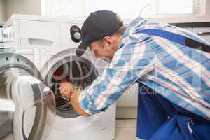 Handyman fixing a washing machine