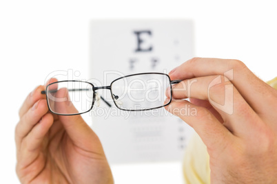 Glasses held up to read eye test