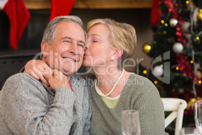 Mature woman kissing the cheek of her husband