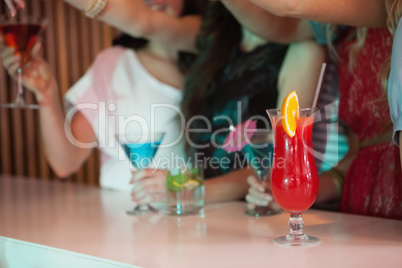 Attractive friends drinking at the bar