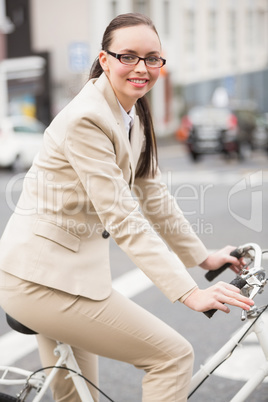 Young businesswoman riding her bike