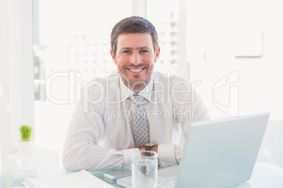 Smiling businessman at desk