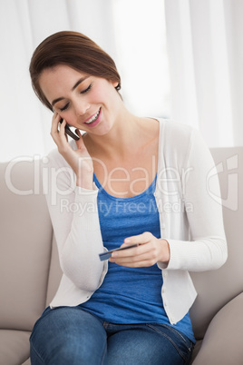 Pretty brunette paying over the phone