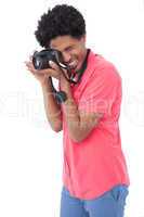 Happy man taking photograph with digital camera