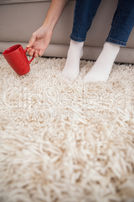 Woman picking up a mug