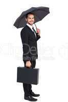 Smiling businessman under umbrella with a briefcase