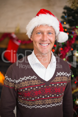 Portrait of a smiling handsome man in santa hat