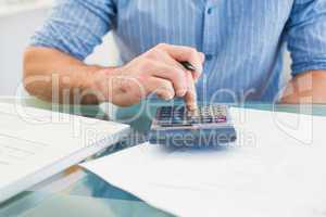 A businessman working on his finances at his desk